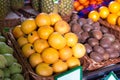 Pile of juicy oranges in wicker baskets on market counter Royalty Free Stock Photo