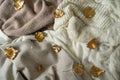 Pile of knitted clothes with autumn gold leaves, warm background, knitwear, space for text, Autumn winter concept. Royalty Free Stock Photo