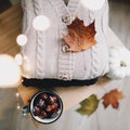 Pile of knitted  clothes on wooden background, sweaters, knitwear, leaf. Cozy autumn, winter concept. Knitted wool sweaters Royalty Free Stock Photo