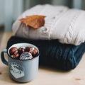 Pile of knitted  clothes on wooden background, sweaters, knitwear, leaf. Cozy autumn, winter concept. Knitted wool sweaters Royalty Free Stock Photo