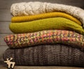 Pile of knitted clothes on wooden background