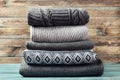 Pile of knitted winter clothes on wooden background, sweaters, knitwear Royalty Free Stock Photo