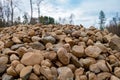 A pile of landscape rocks of various sizes with trees in the distance Royalty Free Stock Photo