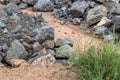 Pile of large granite stones near the grass.