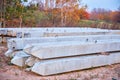 A pile of large and sturdy new concrete pillars or a cement pillar used to build the foundation of a house