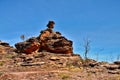 Pile of layered rocks on rugged landscape under blue sky in Australia