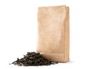 A pile of leaf tea near a paper pack on a white, isolated