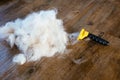 Pile of light gray cat fur from a Ragdoll, siamese, persian, maine cool cat next to a yellow brush comb Royalty Free Stock Photo