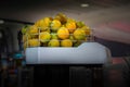 Pile of limes caged and piled up in commercial juicing machine ready to process