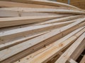 pile of long square section wooden sticks, slightly bent