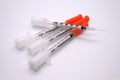 Pile of loose insulin syringes with one needle showing Royalty Free Stock Photo