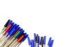 Pile of a lot multi colored plastic ballpoint pens isolated on white background. Abstract stationery background. 16x9 format. Top