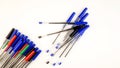 Pile of a lot multi colored plastic ballpoint pens on white background. Abstract stationery background. 16x9 format. Top view. Royalty Free Stock Photo