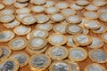 A pile with a lot of Real brazilian money coins on a wood table
