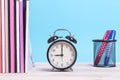 A pile of Magazine books and with coloured pen and alarm clock o Royalty Free Stock Photo