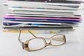Pile of magazine and eyeglasses Royalty Free Stock Photo