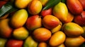 A pile of mangoes with leaves