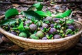 A pile of mangosteen fruit in a rattan basket