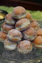 Pile of sugared donuts in the showcase of the pastry shop