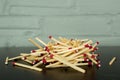 Pile of matches against brick wall background Royalty Free Stock Photo