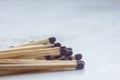 A pile of matches close up on a white table. Macro fire igniter on blurred background Royalty Free Stock Photo