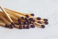 A pile of matches close up on a white table. Macro fire igniter on blurred background Royalty Free Stock Photo