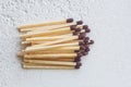 A pile of matches close up on a white table. Macro fire igniter on blurred background. top view Royalty Free Stock Photo