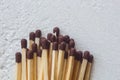 A pile of matches close up on a white table. Macro fire igniter on blurred background. top view Royalty Free Stock Photo