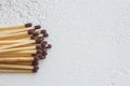 A pile of matches close up on a white table. Macro fire igniter on blurred background. top view Royalty Free Stock Photo