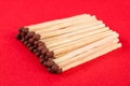 Pile of matches on a red background Royalty Free Stock Photo