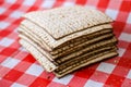 Pile of matza or matzah, cracked matzoth, Jewish traditional holiday food, square shape snack