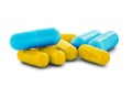 Pile of medical pills in yellow and blue colors on white  background with shadow Royalty Free Stock Photo