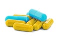 Pile of medical pills in yellow and blue colors on white isolated background with shadow Royalty Free Stock Photo