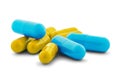 Pile of medical pills in yellow and blue colors on white isolated background with shadow Royalty Free Stock Photo