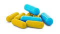 Pile of medical pills in yellow and blue colors on white isolated background with shadow Royalty Free Stock Photo