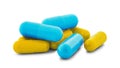 Pile of medical pills in yellow and blue colors on white isolated background with shadow Royalty Free Stock Photo