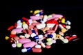 Pile of medicine pills tablets capsules in black background Royalty Free Stock Photo