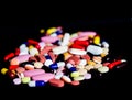 Pile of medicine pills tablets capsules in black background Royalty Free Stock Photo