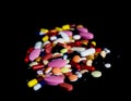 Pile of medicine pills tablets capsules in black background Royalty Free Stock Photo