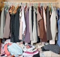 Pile of messy clothes in closet. Untidy cluttered woman wardrobe