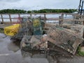 pile of metal lobster traps on dock near water Royalty Free Stock Photo