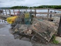 pile of metal lobster traps on dock near water Royalty Free Stock Photo