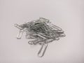 Pile of metal paper clips on a white background Royalty Free Stock Photo