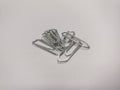Pile of metal paper clips on a white background Royalty Free Stock Photo