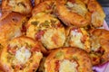 Pile of mini pizzas, Pizza is a dish of Italian origin consisting of a usually round, flat base of leavened wheat-based dough