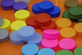 The pile of multi color plastic caps of drinking water bottles Royalty Free Stock Photo