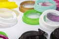 The pile of multi-colors plastic drinking cup lid from injection processing.