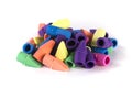 Pile of multicolored rubber pencil topper erasers yellow blue purple pink