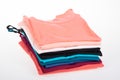 Pile of multicolored tank tops t shirt fabric cotton t-shirts pile of various colored shirts on white table background Royalty Free Stock Photo