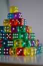 Pile of multiple coloured plastic arcylic d6 six sided die dice variable focus Royalty Free Stock Photo